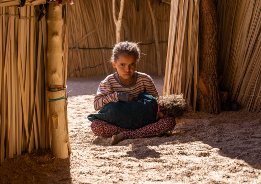 Tuareg girl with her little sister in a reed house, North Africa, Tamanrasset, Algeria