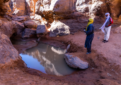 Tuaregs near a waterhole in the desert, Tassili N'Ajjer National Park, Tadrart Rouge, Algeria