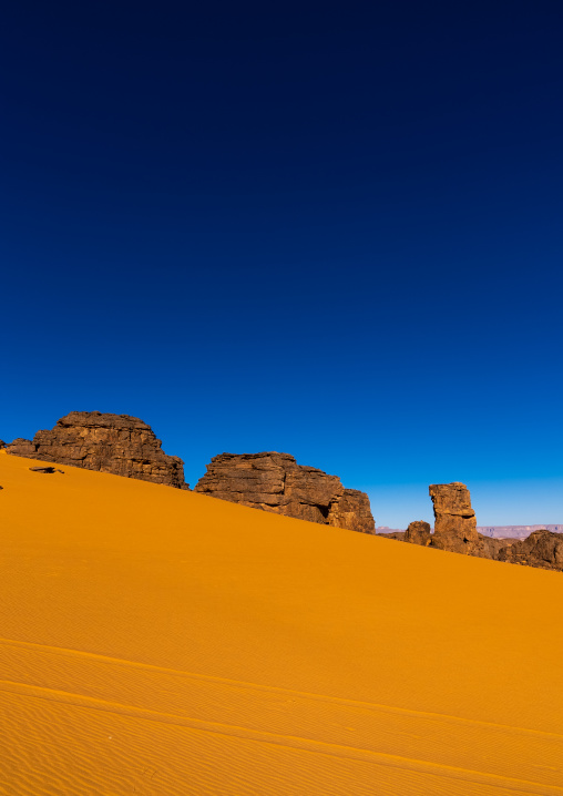 Rocks and sand dunes in Sahara desert, North Africa, Erg Admer, Algeria