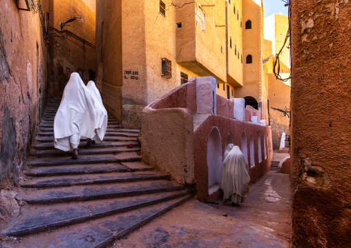 Mozabite women in white haïk in the streets of Ksar El Atteuf, North Africa, Ghardaia, Algeria