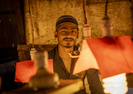 Bangladeshi man behind lamps in the market, Dhaka Division, Dhaka, Bangladesh