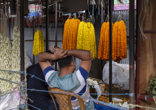 Bangladeshi man selling garland flowers at flower market, Dhaka Division, Dhaka, Bangladesh