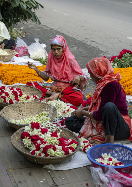 Women selling garlands of flowers at flower market, Dhaka Division, Dhaka, Bangladesh