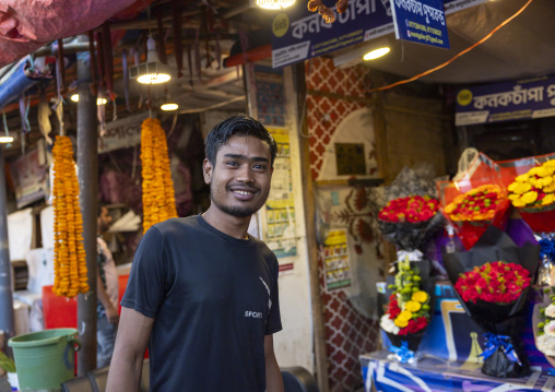 Bangladeshi man selling garland flowers at flower market, Dhaka Division, Dhaka, Bangladesh