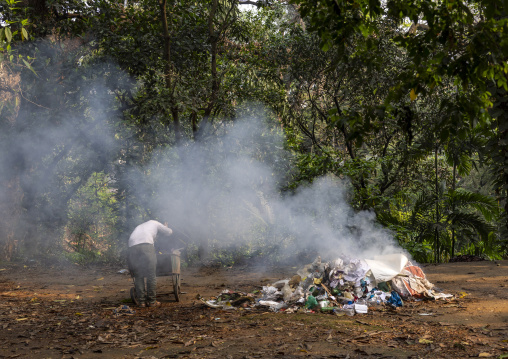 Bangladeshi man burning garbage, Dhaka Division, Dhaka, Bangladesh