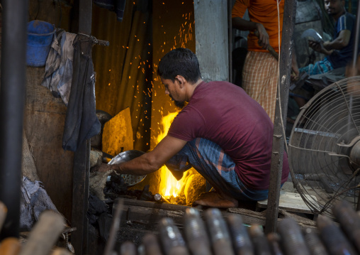 Bangladeshi blacksmith working at Kawran bazar, Dhaka Division, Dhaka, Bangladesh