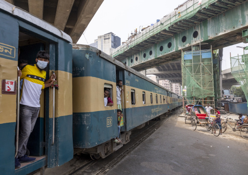 Passengers in a train passing in Kawran bazar, Dhaka Division, Dhaka, Bangladesh