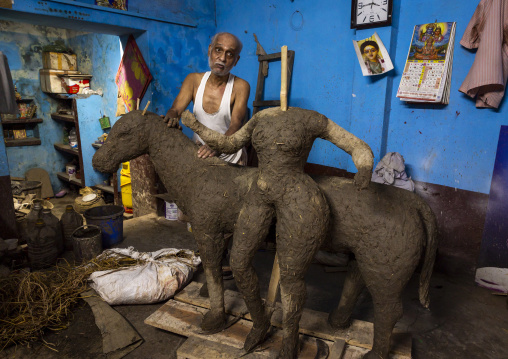 Old bangladeshi man making a religious sculpture, Dhaka Division, Dhaka, Bangladesh