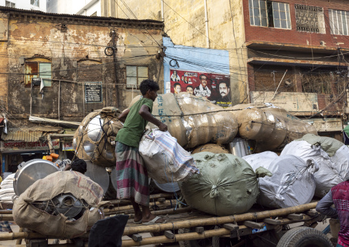 Bangladeshi man collectings bags to recycle metal, Dhaka Division, Dhaka, Bangladesh