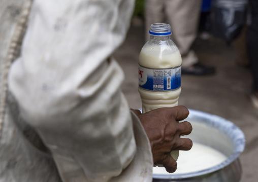 Bangladeshi man with a milk bottle for ramadan iftar, Dhaka Division, Dhaka, Bangladesh