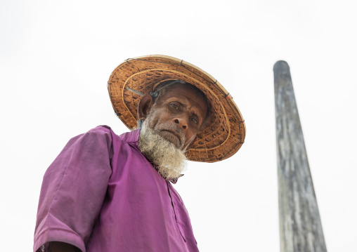 Old male worker with a bamboo hat at a brick factory, Sylhet Division, Bahubal, Bangladesh