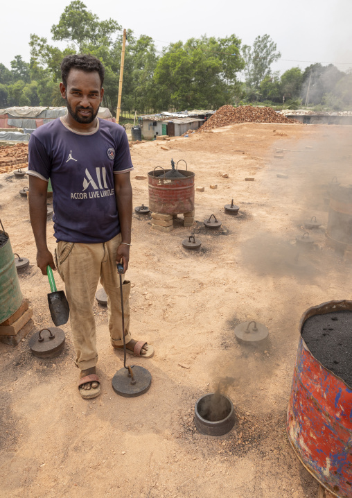 Worker on the roof of the giant oven at a brick factory, Sylhet Division, Bahubal, Bangladesh