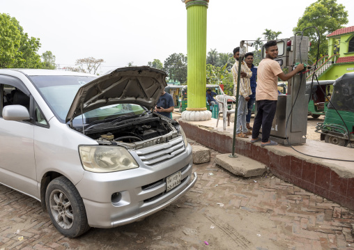 A car is fueled with compressed natural gas at a pump station, Chittagong Division, Ashuganj, Bangladesh