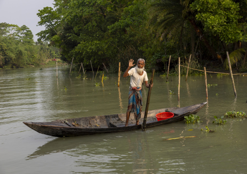 Old man on a local boat on a river, Barisal Division, Banaripara, Bangladesh