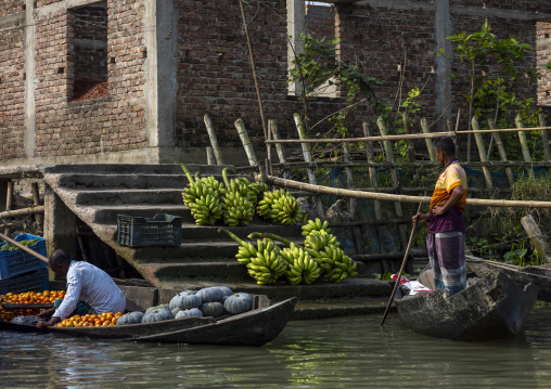 Bangladeshi men selling fruits and vegetables at weekly floating market, Barisal Division, Harta, Bangladesh