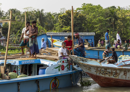 Bangladeshi men selling fruits and vegetables at weekly floating market, Barisal Division, Harta, Bangladesh