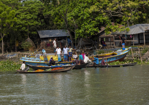 Bangladeshi men selling fruits and vegetables at weekly floating market, Barisal Division, Harta, Bangladesh