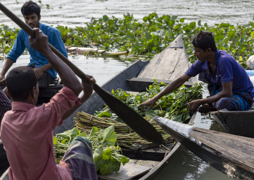 Bangladeshi men selling fruits and vegetables at weekly floating market, Barisal Division, Harta, Bangladesh