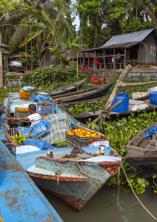 Bangladeshi men selling fruits and vegetables at weekly floating market, Barisal Division, Harta, Bangladesh