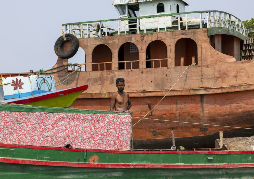 Bangladeshi shirtless man on a boat in Sundarbans, Barisal Division, Nesarabad, Bangladesh