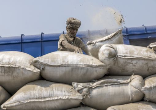 Bangladeshi workers unloading cement bags from a train, Khulna Division, Abhaynagar, Bangladesh