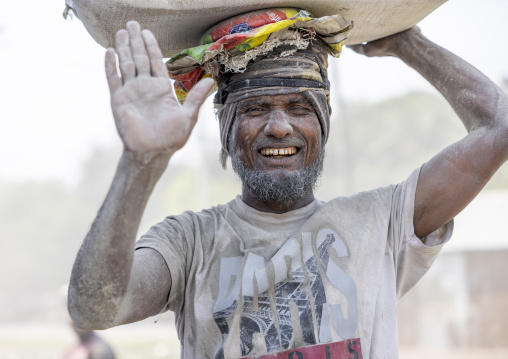 Bangladeshi porter carrying cement bag, Khulna Division, Abhaynagar, Bangladesh