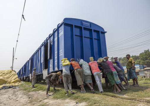 Bangladeshi workers pushing a blue train, Khulna Division, Abhaynagar, Bangladesh