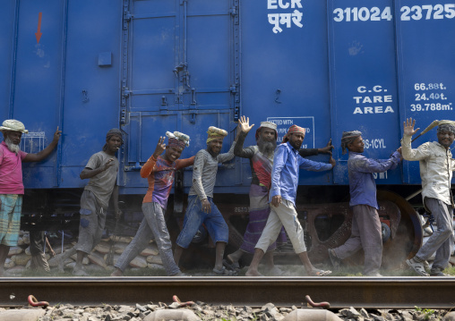 Bangladeshi workers pushing a blue train in line, Khulna Division, Abhaynagar, Bangladesh