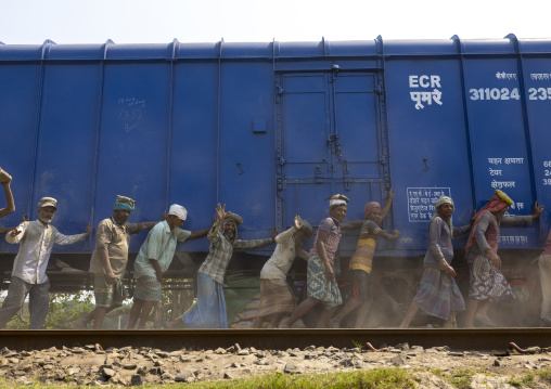 Bangladeshi workers pushing a blue train in line, Khulna Division, Abhaynagar, Bangladesh