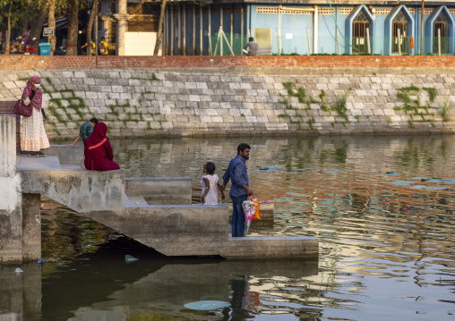 Bangladeshi people on the stairs of a pond, Khulna Division, Jessore, Bangladesh