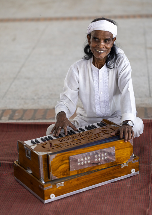 Devotee playing harmonium in Mausoleum of Lalon Shah, Khulna Division, Cheuriya, Bangladesh