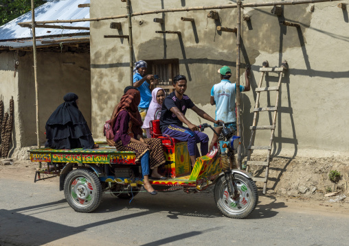 Bangladeshi man driving a rickshaw with women, Rajshahi Division, Manda, Bangladesh