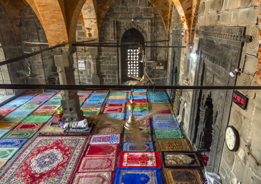 Bangladeshi man sleeping on carpets inside Kusumba mosque, Naogaon District, Manda Upazila, Bangladesh