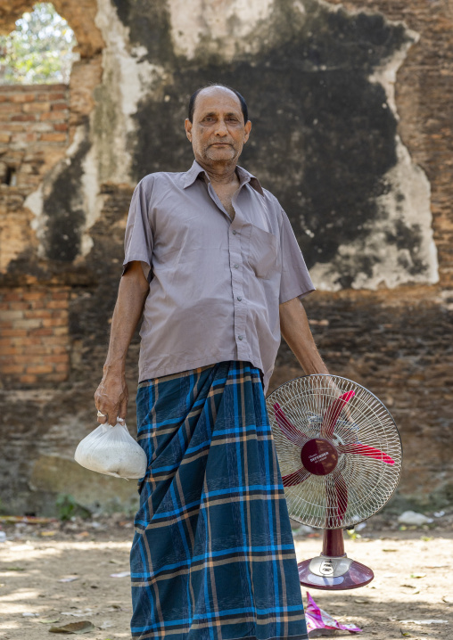 Portrait of a bangladeshi man with an electric fan, Rajshahi Division, Naogaon Sadar, Bangladesh