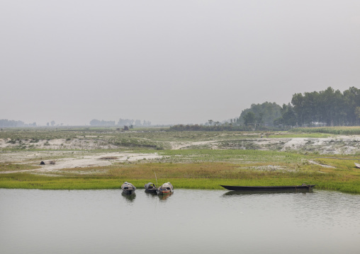 Local boats on a quiet river, Rajshahi Division, Sariakandi, Bangladesh