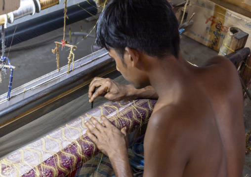 Bangladeshi man weaving in a sari factory, Dhaka Division, Rupganj, Bangladesh