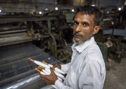 Bangladeshi man working in a extile factory looms, Dhaka Division, Rupganj, Bangladesh