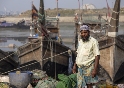 Bangladeshi man unloading fishes in the market, Chittagong Division, Chittagong, Bangladesh