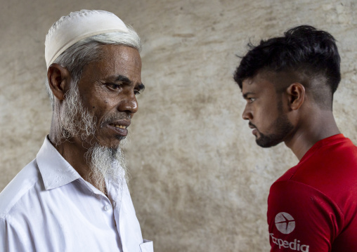 Bangladeshi men crossing each other in the street, Chittagong Division, Chittagong, Bangladesh