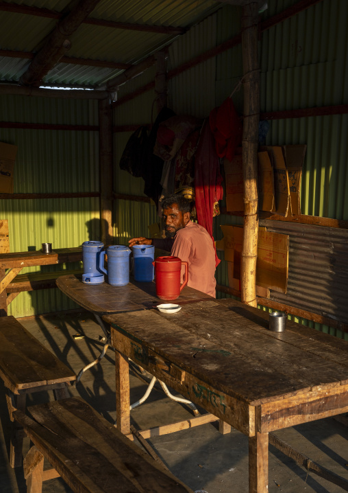 Portrait of a bangladeshi man sit in a bar at sunset, Chittagong Division, Cox's Bazar Sadar, Bangladesh