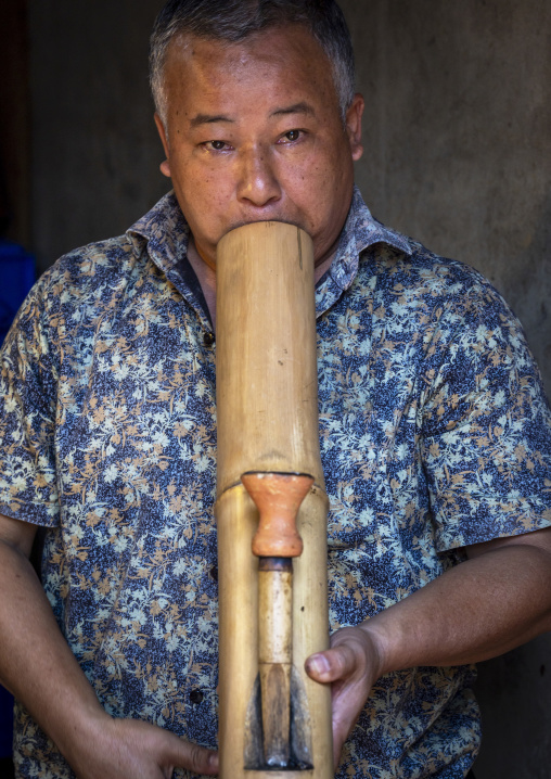 Chakma tribe man smoking bamboo pipe, Chittagong Division, Rangamati Sadar, Bangladesh