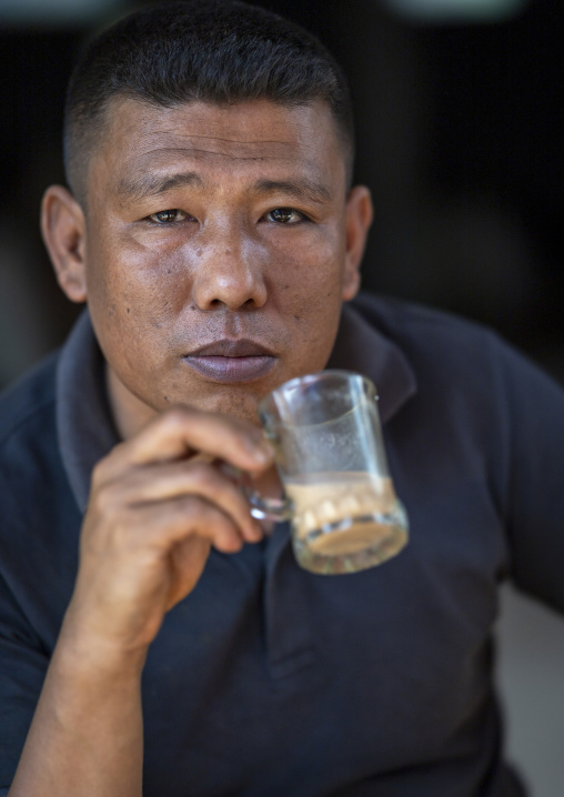 Portrait of a Chakma tribe man drinking tea, Chittagong Division, Rangamati Sadar, Bangladesh