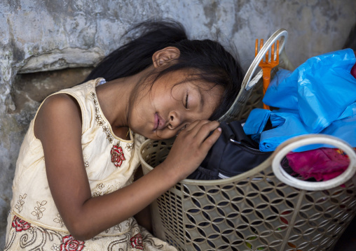 Chakma tribe girl sleeping on a basket, Chittagong Division, Rangamati Sadar, Bangladesh