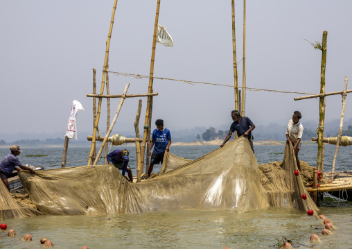 Bangladeshi fishermen pulling out fishing nets from Kaptai Lake, Chittagong Division, Rangamati Sadar, Bangladesh