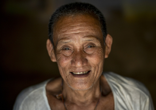 Portrait of a smiling bangladeshi Chakma tribe old man, Chittagong Division, Rangamati Sadar, Bangladesh