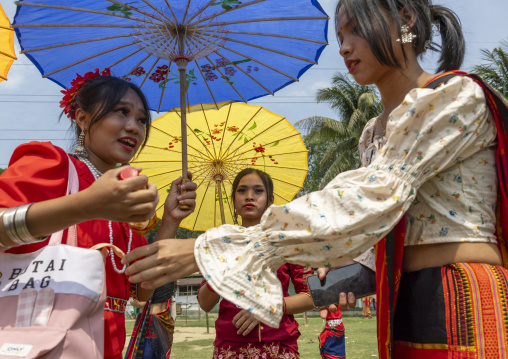 Chakma women with umbrellas in traditional clothing celebrating Biju festival, Chittagong Division, Kawkhali, Bangladesh