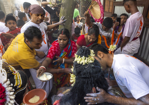 Hindu women give food to Lord Shiva at Lal Kach festival, Dhaka Division, Tongibari, Bangladesh