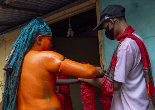 Portrait of a Hindu devotee covered with orange color in Lal Kach festival, Dhaka Division, Munshiganj Sadar, Bangladesh