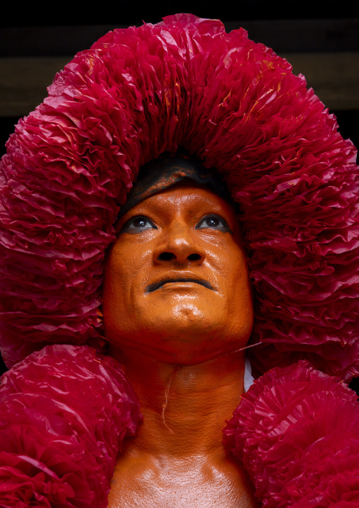 Portrait of a Hindu devotee covered with orange color in Lal Kach festival, Dhaka Division, Munshiganj Sadar, Bangladesh