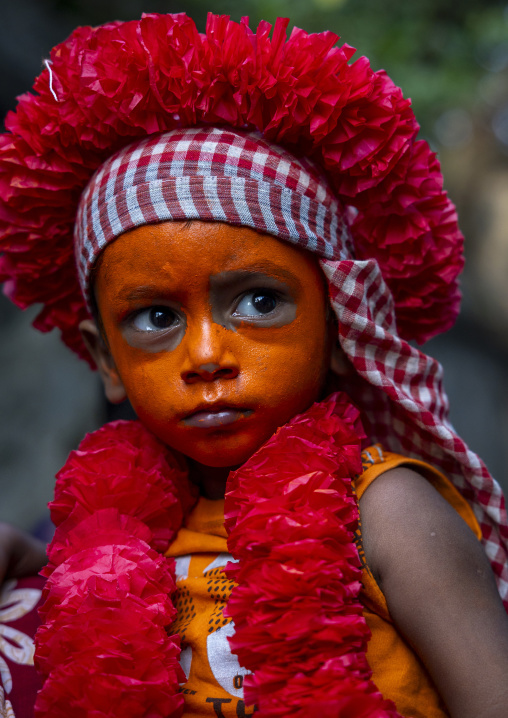 Hindu devotee boy covered with orange color in Lal Kach festival, Dhaka Division, Munshiganj Sadar, Bangladesh